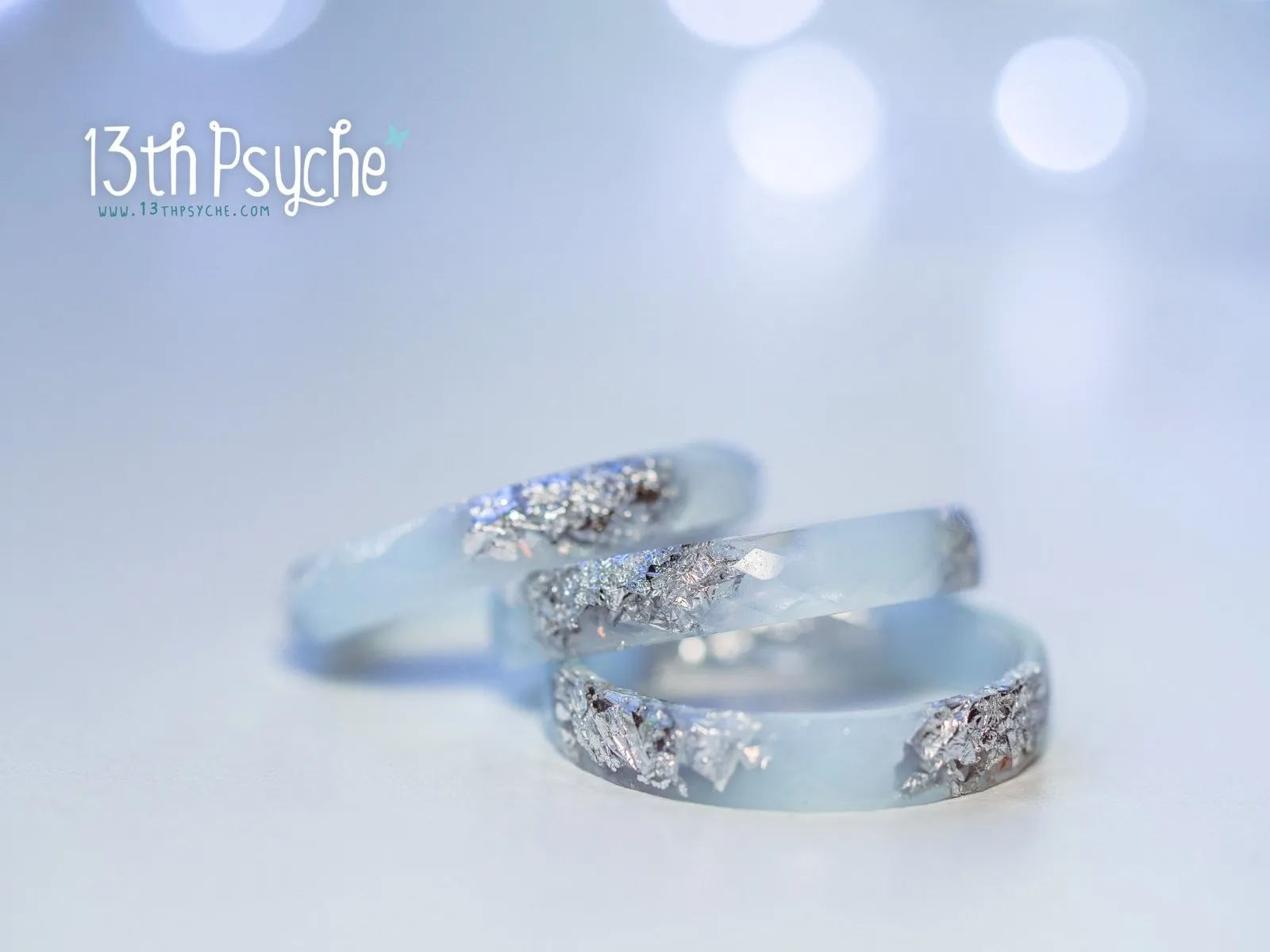 Pastel blue faceted resin ring with silver flakes