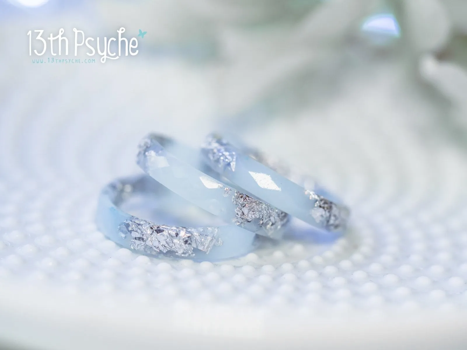 Pastel blue faceted resin ring with silver flakes